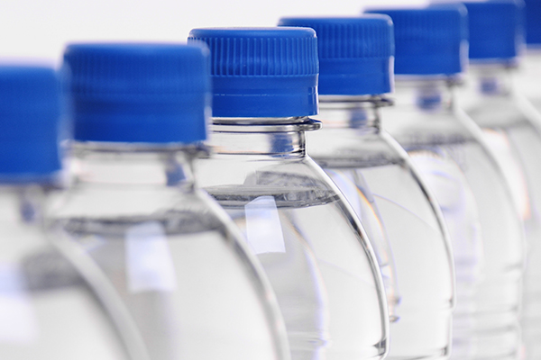 select focus on middle bottle in a row of water bottles