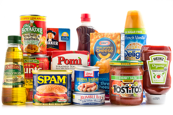 Miami, Florida, USA - June 1, 2015: Selection of brand name groceries. In full view are SPAM meat, Libby's Viena sausages, Pompeian Olive Oil, Heinz brand Tomato Ketchup, Bubble Bee Tuna, Tostitos Salsa, Chez Boyardee Spaghetti and meat balls. Other products are partially visible in the background.This is a collection of some of the basic staples found in many American kitchens. Other brands includes Kirkland, Quaker Oats, Pomi,Aunt Jemima, Kraft,Hunt's,and International delight.